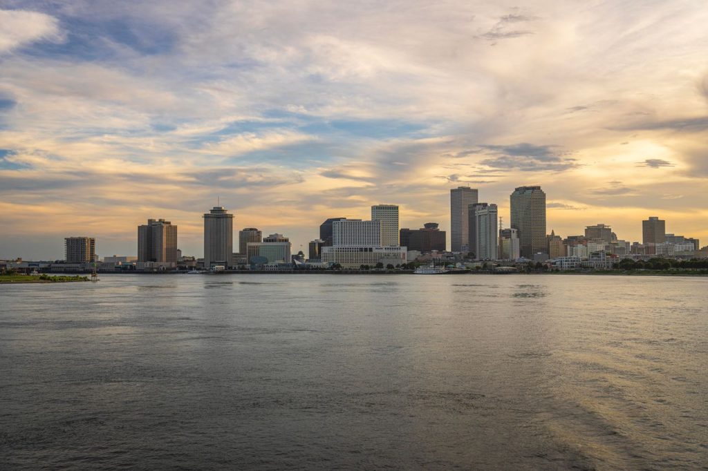 Beautiful skyline of New Orleans across the Mississippi River during sunset.